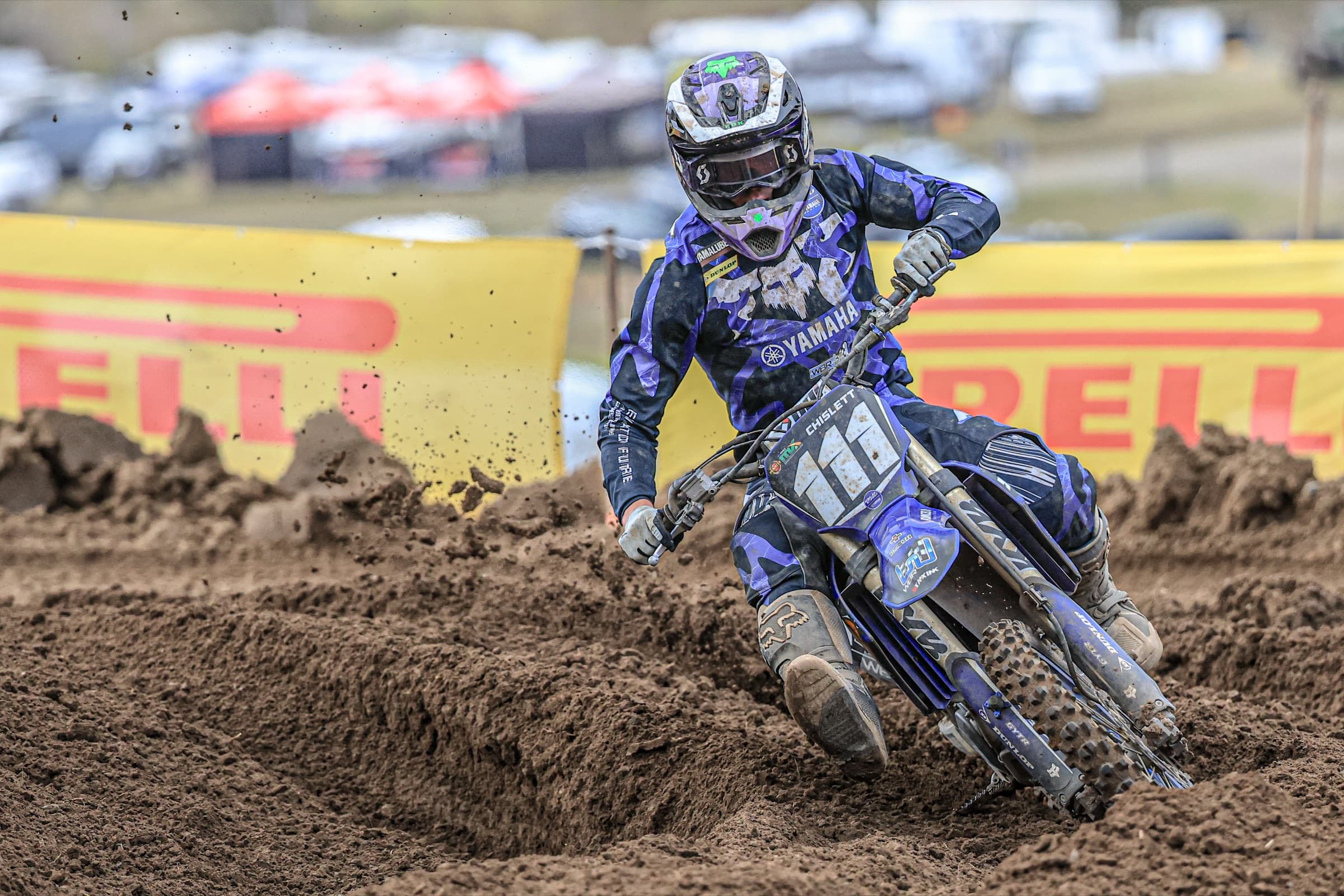 Judd Chislett racing past trackside sponsor banners