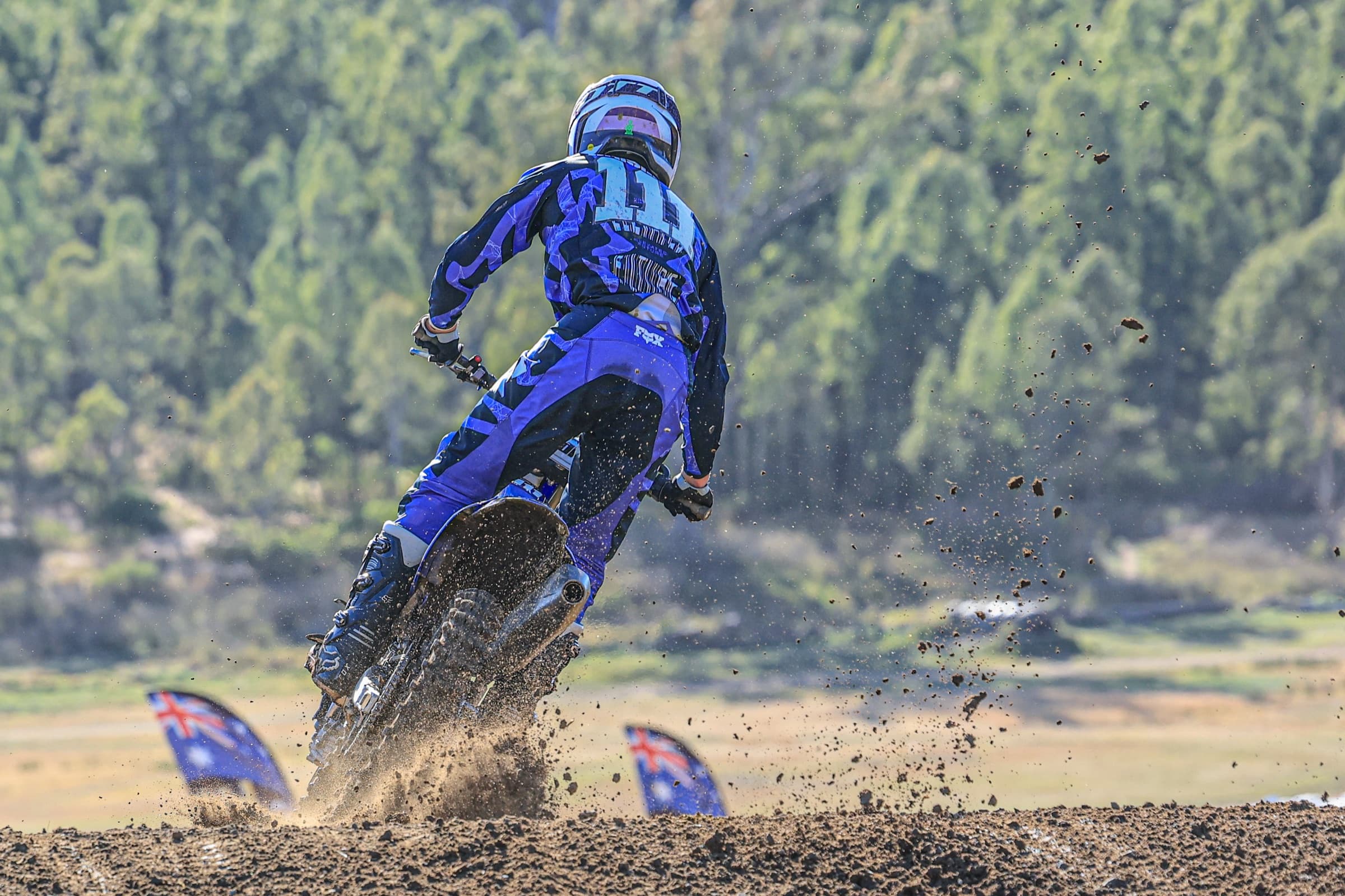 Roost flying off a motocross berm